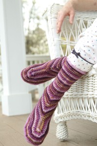 Irises - This impressionistic rendering of iris beds uses a simple slip-stitch technique and requires handling only one color per round.